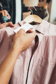 Fashion Shopping - Close Up of Man Checking Out Price Tag on Vintage Shirt