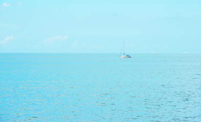 Fototapeta premium Sailing boat sailing in a lake in sunlight in summer