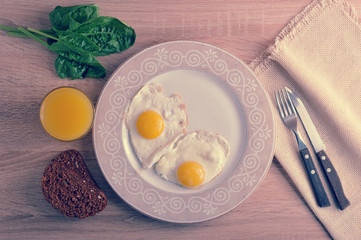 scrambled eggs with spinach on the plate - a healthy Breakfast with orange juice