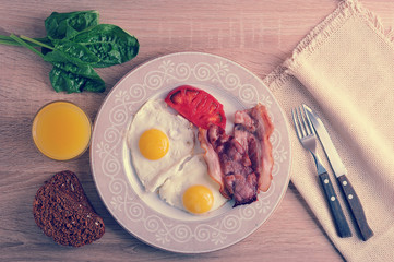 scrambled eggs with bacon, spinach and beans on the plate