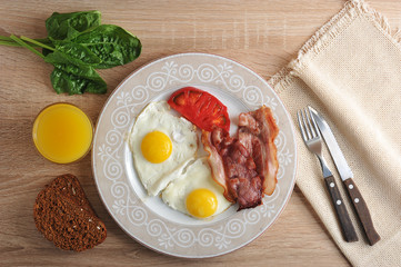scrambled eggs with bacon, spinach and beans on the plate