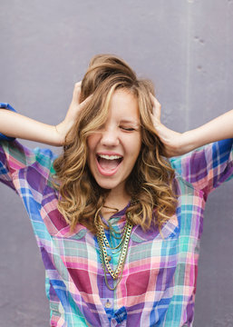 Teen girl holding her head and happy