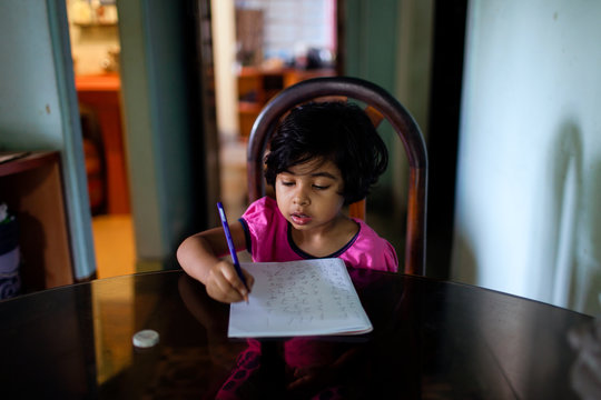 Cute little girl writing in a notebook