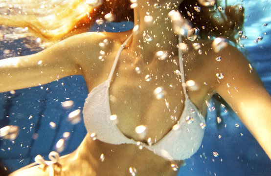 woman in white bikini underwater
