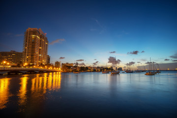 Light Reflecting on Water as Boats Drift in the Bay