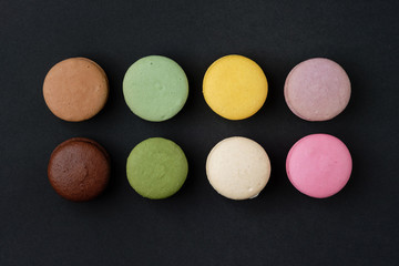 French macaroons on black background