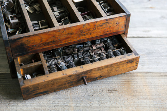Old wood drawer filled with vintage metal numbering inserts for printer