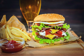 Big Burger and light beer on a wooden table