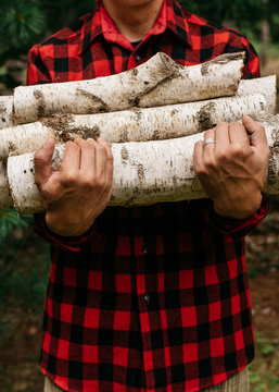 Man holding wood for fire