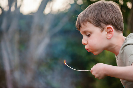 Young child playing with fire