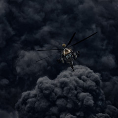 Attack helicopter against the background of smoke. after the mission. Modern russian attack helicopter with with weapons