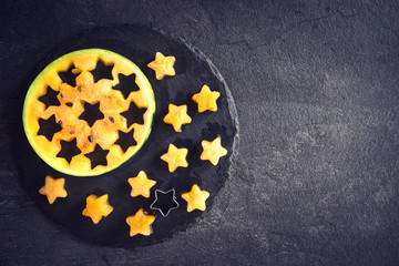 Served orange watermelons in star shapes on dark background with blank space