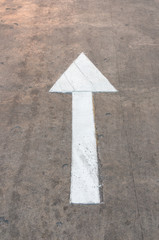White arrow symbol on the road 
