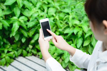 Closeup of woman hands using smartphone