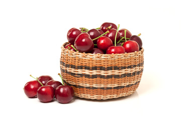 Red Cherries in a basket on white background