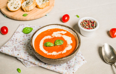 Colorful cream of tomato soup against white background. Healthy food, diet, and fitness concept