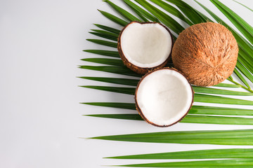 Coconut with half and leaves on white background