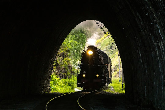 Fototapeta Old steam locomotive enters the tunnel on the Circum-Baikal Railway
