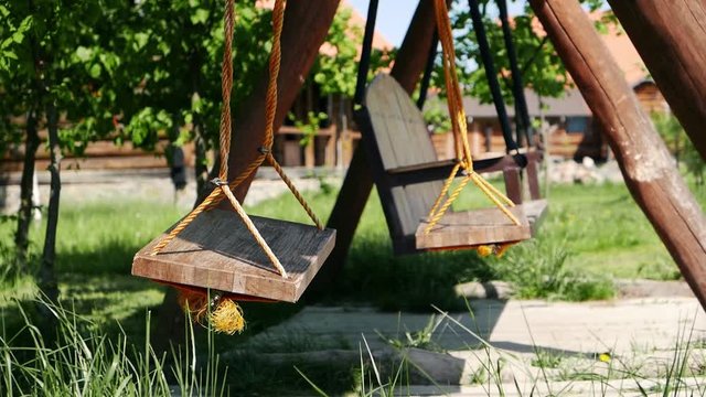 Empty swings move. Loneliness, sadness, emptiness. Lack of people and childen