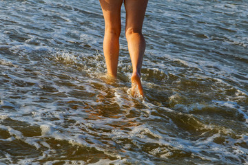 Beautiful woman legs on the beach