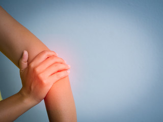 Closeup female's elbow. Arm pain and injury. Health care and medical concept.