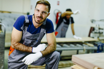 Fototapeta na wymiar Young workers working in furniture factory