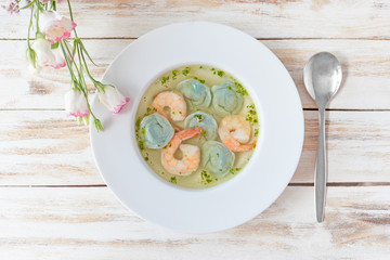 Soup dumplings and shrimp served with leek. On old wooden white background.
