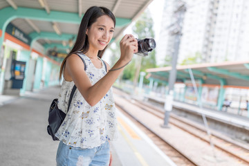 Woman taking photo in Hong Kong light rail station