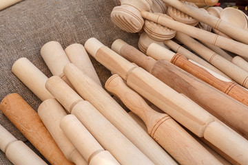 Various rolling-pin and a hammer for pounding meat from wood. Wooden household items are presented at the fair. Traditional Belarusian crafts.