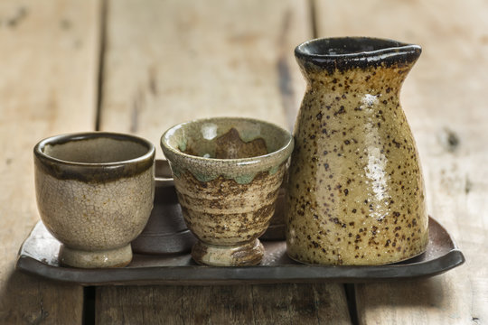 Close-Up Variety Of Sake Cups On Ancient Glass Trays.