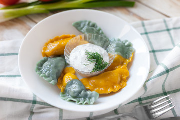 Vareniki called also dumplings, varenyky. Traditional Ukrainian cuisine (food). 
On old wooden white background.