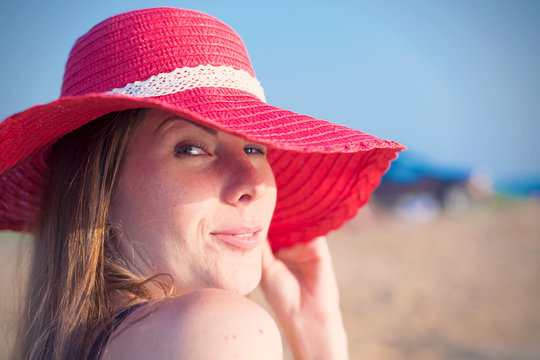 Young Smiling Woman In The Red Sun Hat