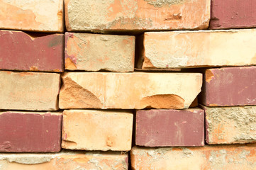 Old clay bricks stacked in the wall as a background.