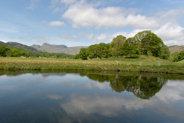 Fototapeta na wymiar Langdale Pikes reflected in River Brathay, English Lake District