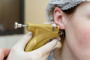 Ear piercing to piercing.
