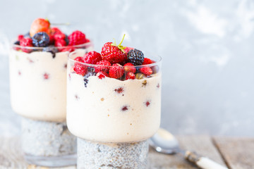 Healthy chia pudding with smoothies and berries in a glass.