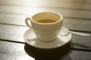 Cup of coffee on wooden table.