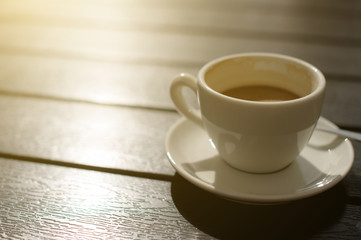 Cup of coffee on wooden table.