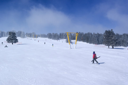 Skiers and snowboarders on a ski lift