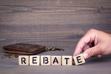 Rebate. Wooden letters on dark background. Office desk