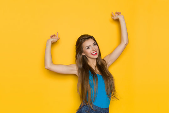 Happy Young Beautiful Woman With Arms Raised