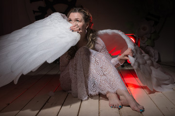 Ugly woman in a white dress with white wings
