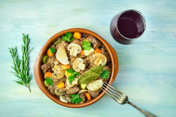 Overhead photo of meat and mushrooms ragout with wine