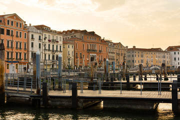 Fototapeta na wymiar An old wooden pier on Venice, Italy at sunrise