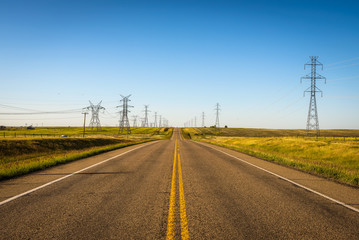 Electricity Pillars along an empty road in Canada