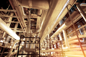 Equipment, cables and piping as found inside of a modern industrial power plant