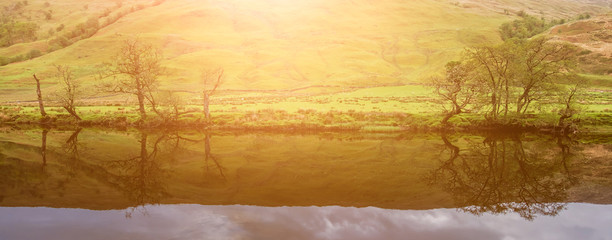 Trees reflecting on the river Orchy, Glen Orchy, Scotland