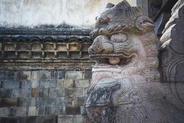 detail shot of stone lion guardian statue.