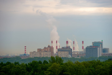 Obraz premium View of the district of the city of Moscow with high-rise buildings and pipes of a thermal power plant