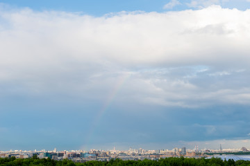 Beautiful and large sky with clouds and rainbow over downtown Moscow